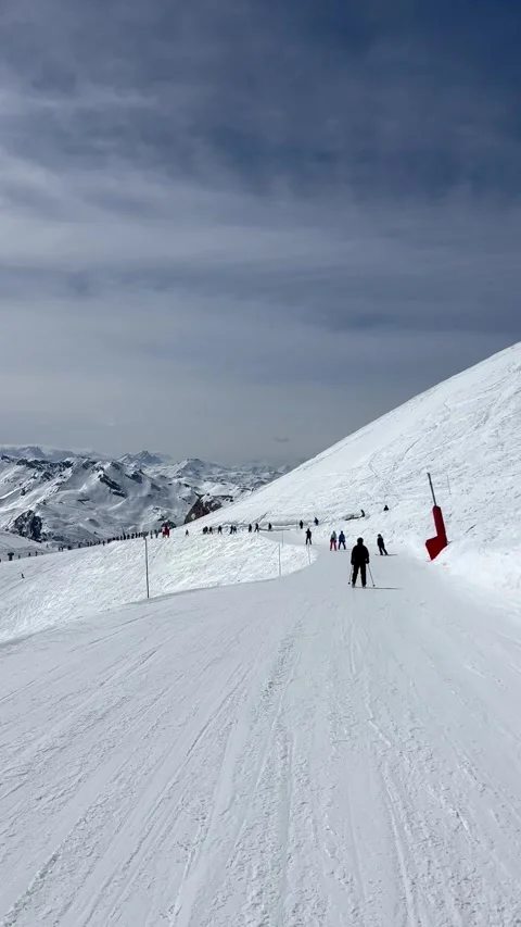 Skiers on the slopes of Courchevel ski resort by winter Stock Footage 337097341