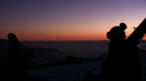 Skiers walking at sunset Stock Footage 33649960