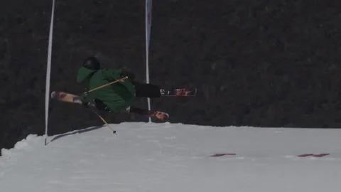 Skiier in dark green/black performs another jump. Stock Footage 81882412