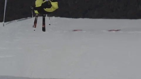 Skiier in fluro yellow performs jump. Stock Footage 81882447