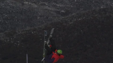 Skiier in red/yellow performs another jump. Stock Footage 81882405