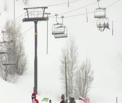 Skiiers gather at the base of hill while snow falls Stock Footage 21672668