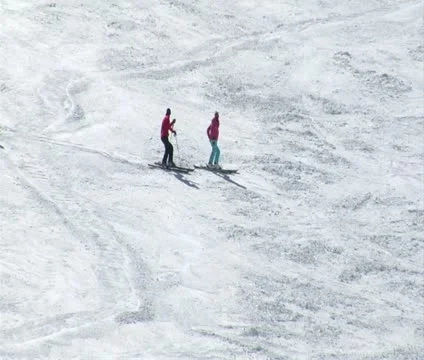 Skiiers wait on hill while other pass by Stock-Footage 21672157