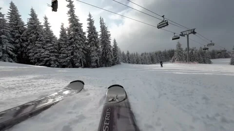 Skiing. Action camera low angle view of skis of skier going downhill on ski Stock Footage 232837877