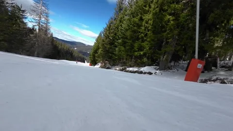 Skiing. Action camera low angle view of skis of skier going downhill on ski Stock Footage 248757941