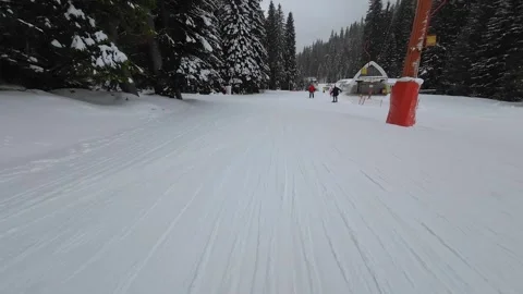 Skiing. Action camera low angle view of skis of skier going downhill on ski Stock Footage 254354480