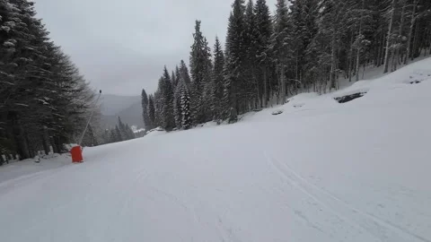 Skiing. Action camera low angle view of skis of skier going downhill on ski Stock Footage 256096970