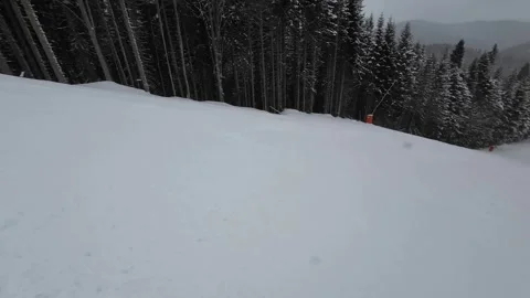 Skiing. Action camera low angle view of skis of skier going downhill on ski Stock Footage 258328231