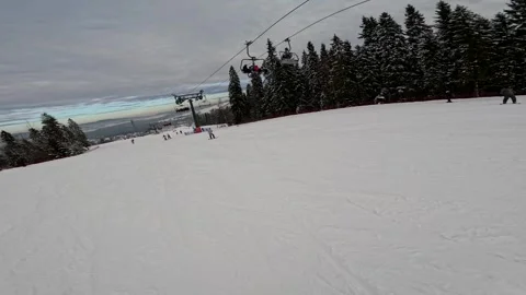 Skiing and snowboarding at a mountain resort in winter Stock Footage 326319933