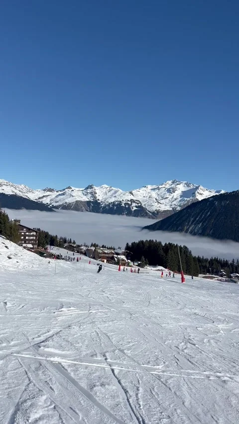 Skiing in Courchevel ski resort under clouds by winter,French alps Stock Footage 334410946