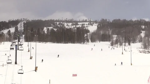 Skiing down Mountain next to Ski Lift in Colorado Stock Footage 93375812