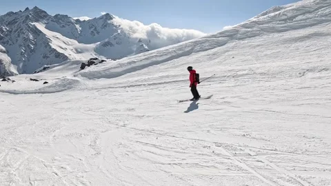 Skiing down sunny alpine slopes in winter Stock Footage 281600291