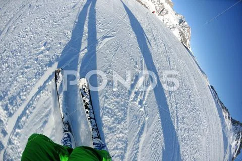 Skiing on fresh snow at winter season at beautiful sunny day Stock Photos