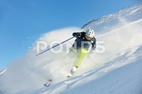 Skiing on fresh snow at winter season at beautiful sunny day Stock Photos