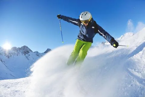 Skiing on fresh snow at winter season at beautiful sunny day Stock Photos