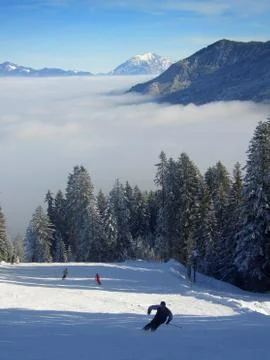 Skiing over the clouds Stock Photos