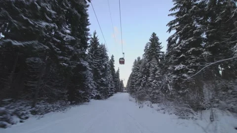 Skiing unter a cable car in winter. Snowy trees and cold weather near the end Stock Footage 221239224