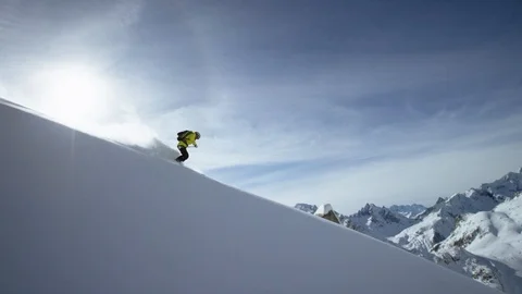 Skilful skier making turns while skiing down the snowy mountain slope Видео 116741288