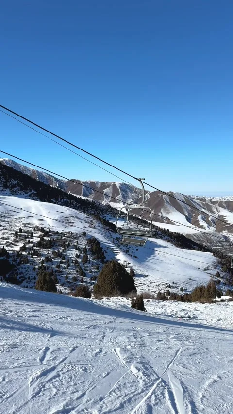 Skilift in motion. Empty cable car on mountain slope at ski resort Stock Footage 299596571