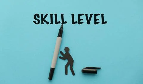 Skill Level text with paper human figure and marker on blue background Foto stock