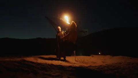 Skilled Acrobat Man Jumping And Performing Flip In Night On Sandy Beach Stock Footage 254318372