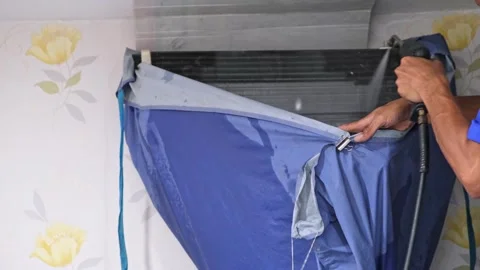 A skilled air conditioning technician is cleaning the AC unit fincoil using.. Stock Footage 300078300