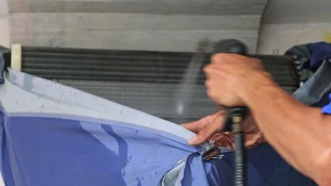 A skilled air conditioning technician is cleaning the condenser fin coin of.. Stock Footage 300082071