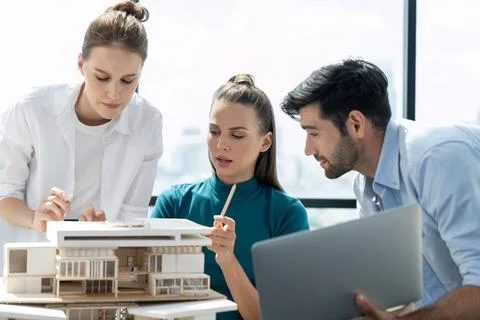Skilled architect holding laptop while present idea to engineer team. Tracery. Stock Photos