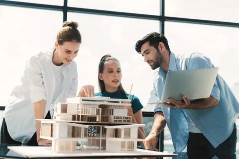 Skilled architect holding laptop while present idea to engineer team. Tracery. Foto stock