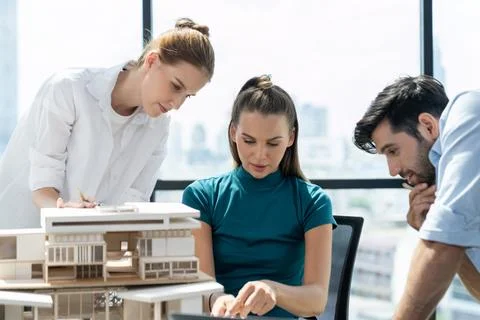 Skilled architect holding laptop while present idea to engineer team. Tracery. Foto stock