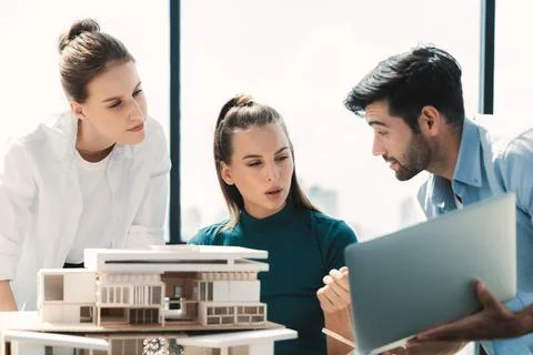 Skilled architect holding laptop while present idea to engineer team. Tracery. Foto stock