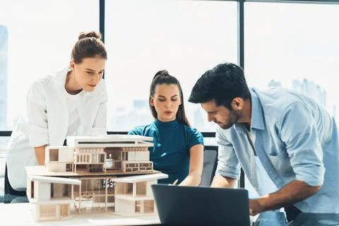 Skilled architect holding laptop while present idea to engineer team. Tracery. Foto stock