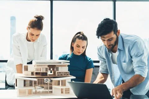Skilled architect holding laptop while present idea to engineer team. Tracery. Foto stock