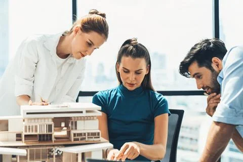 Skilled architect holding laptop while present idea to engineer team. Tracery. Stock Photos