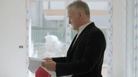 Skilled Architect Or Engineer Looking At Blueprint In New House Stock Footage 117470678