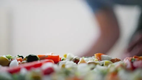 A skilled artisan chef expertly assembles a vibrant pizza topped with a variety Video stock 317780296