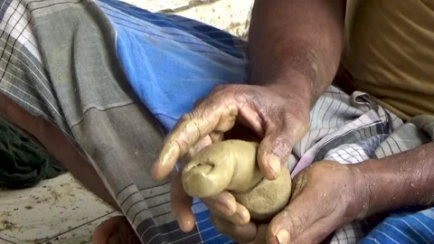 A skilled artisan is gently shaping a clay figure with care in Kumartuli, Stock Footage 314324553
