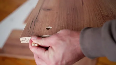 Skilled Artisan Hand Installing a Screw into a Beautifully Crafted Wooden Stock Footage 302656454