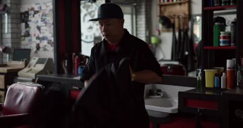 Skilled barber setting up shop before opening in interior hipster barbershop wit Stock Footage 199459876