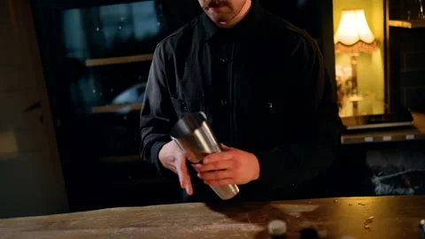 Skilled bartender performs dynamic flair mixology with stainless cocktail Stock Footage 318655201