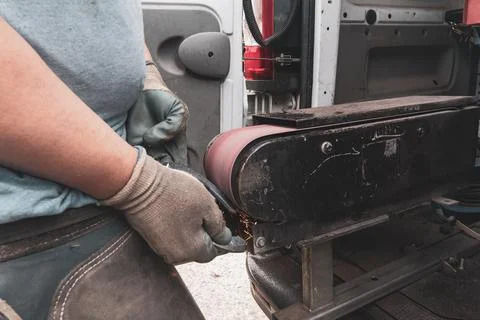 Skilled blacksmith carefully refining a horseshoe in a traditional forge. Stock Photos