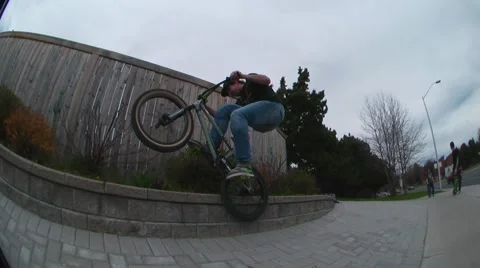 Skilled bmx rider doing his street tricks Stock Footage 51703789