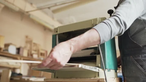 Skilled carpenter using woodworking machine Stock Footage 101797754