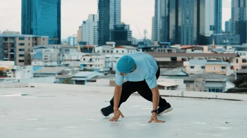 Skilled caucasian B-boy dancer practicing street dancing at rooftop. hiphop. Stock Footage 257789323