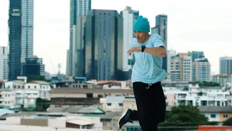 Skilled caucasian B-boy dancer practicing street dancing at rooftop. Endeavor. 库存照片
