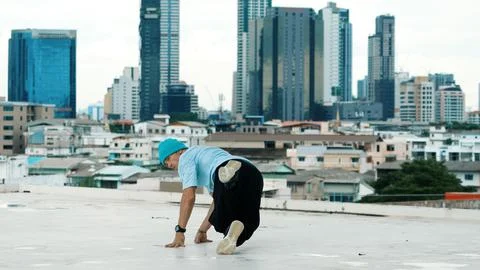 Skilled caucasian B-boy dancer practicing street dancing at rooftop. Endeavor. 写真素材