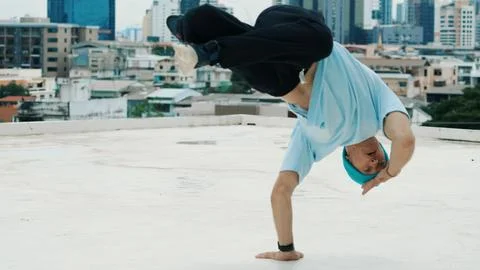 Skilled caucasian B-boy dancer practicing street dancing at rooftop. Endeavor. 写真素材