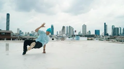 Skilled caucasian B-boy dancer practicing street dancing at rooftop. Endeavor. 写真素材