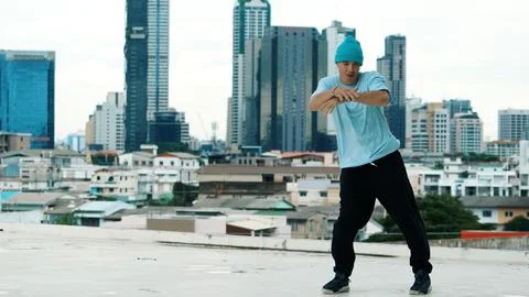 Skilled caucasian B-boy dancer practicing street dancing at rooftop. Endeavor. 写真素材