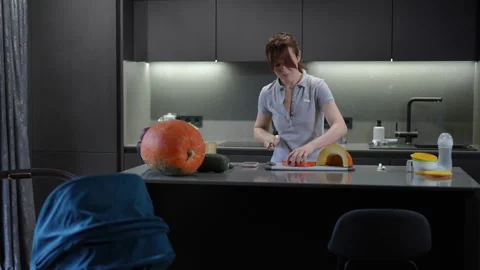 A skilled chef is expertly slicing vibrant fresh produce in a stylish  kitchen  Stock Footage 301434633